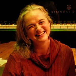 Annabelle Lawson in front of piano keyboard