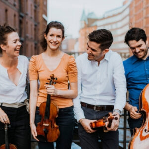Aris Quartet smiling dressed casually